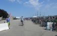 Volunteer directing some of the 1500 bikers per day that park their bikes just outside the main gate in parking area organized by Bike Newport, Folk Festival 2019